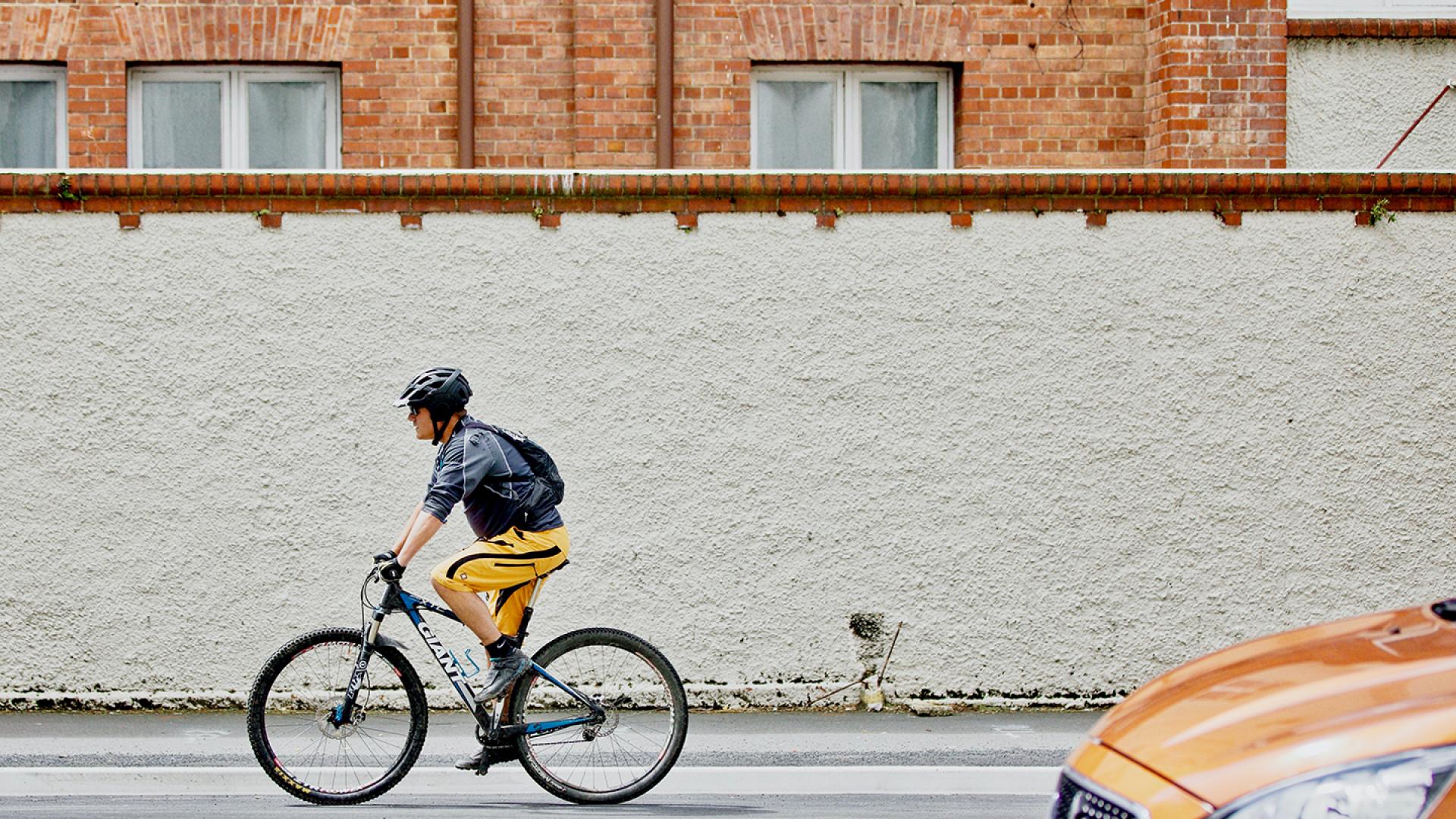 Man riding bike on street