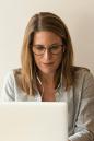 Woman sat at desk with a laptop